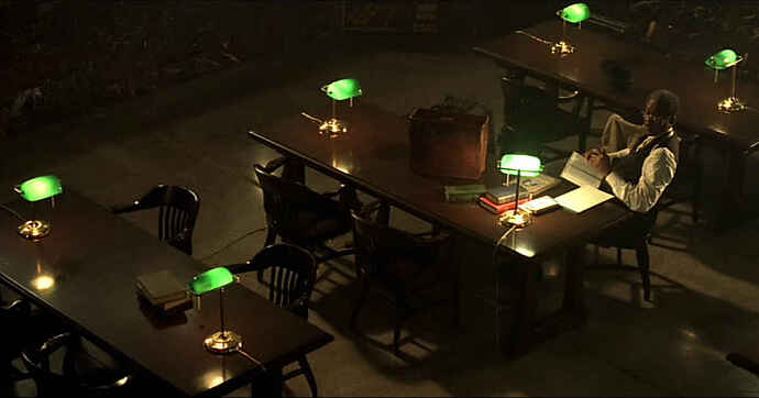 scene from the movie se7en with morgan freeman reading books